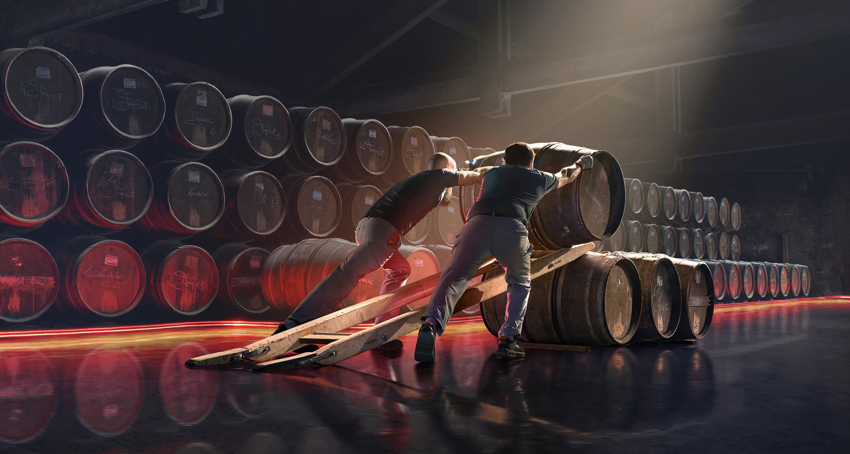 Two Hennessy workers align hundreds of oak barrels in a traditional cellar