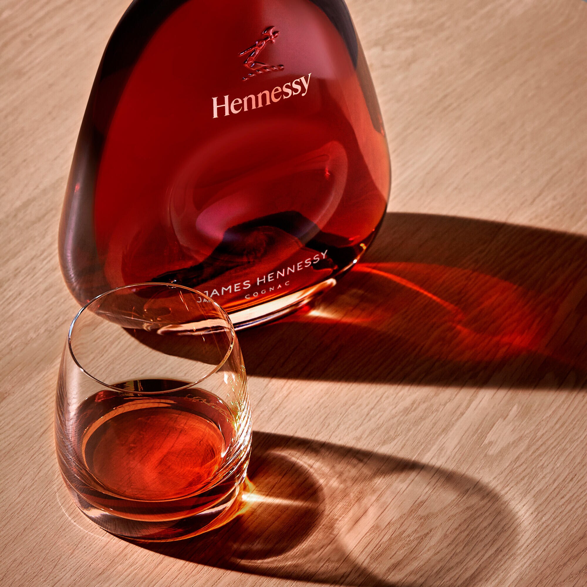 Decanter of James Hennessy, next to a glass of cognac