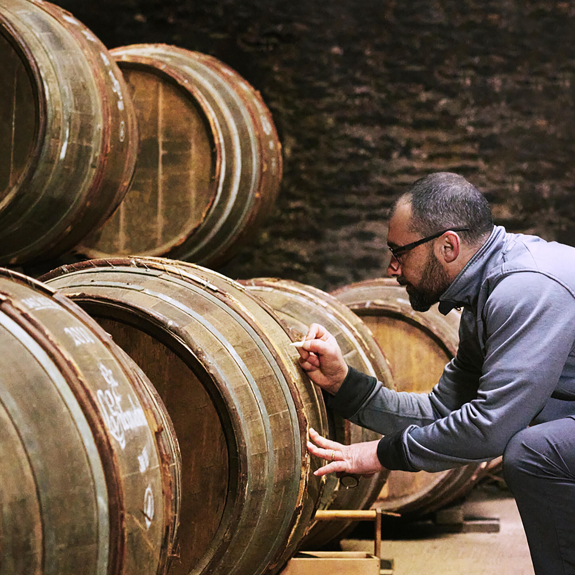 Professional calligrapher working on a barrel in the Hennessy cellars