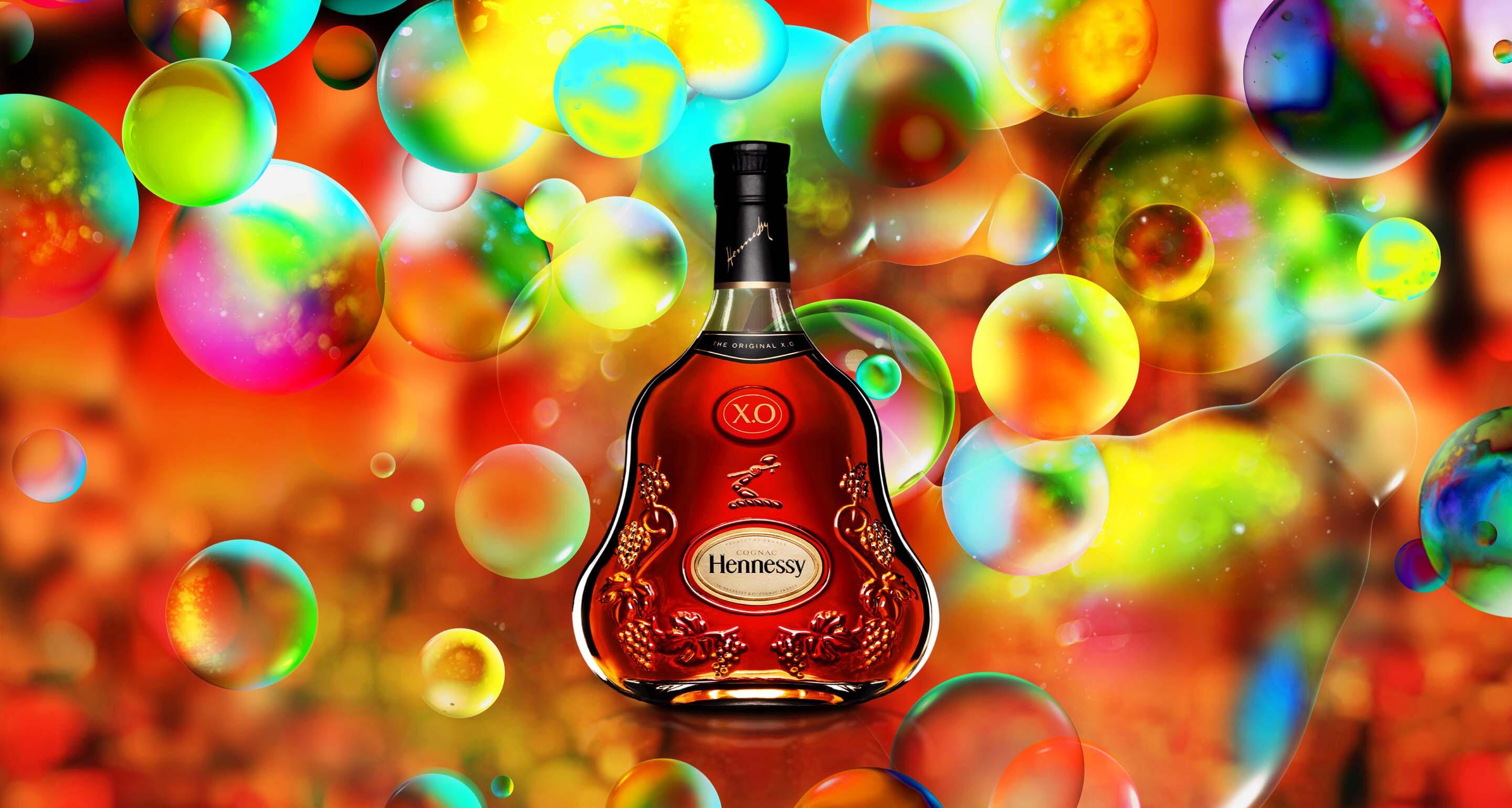 Bottle of Hennessy X.O in front of a detail of Zhang Huan’s celebratory Eaux-de-vie.