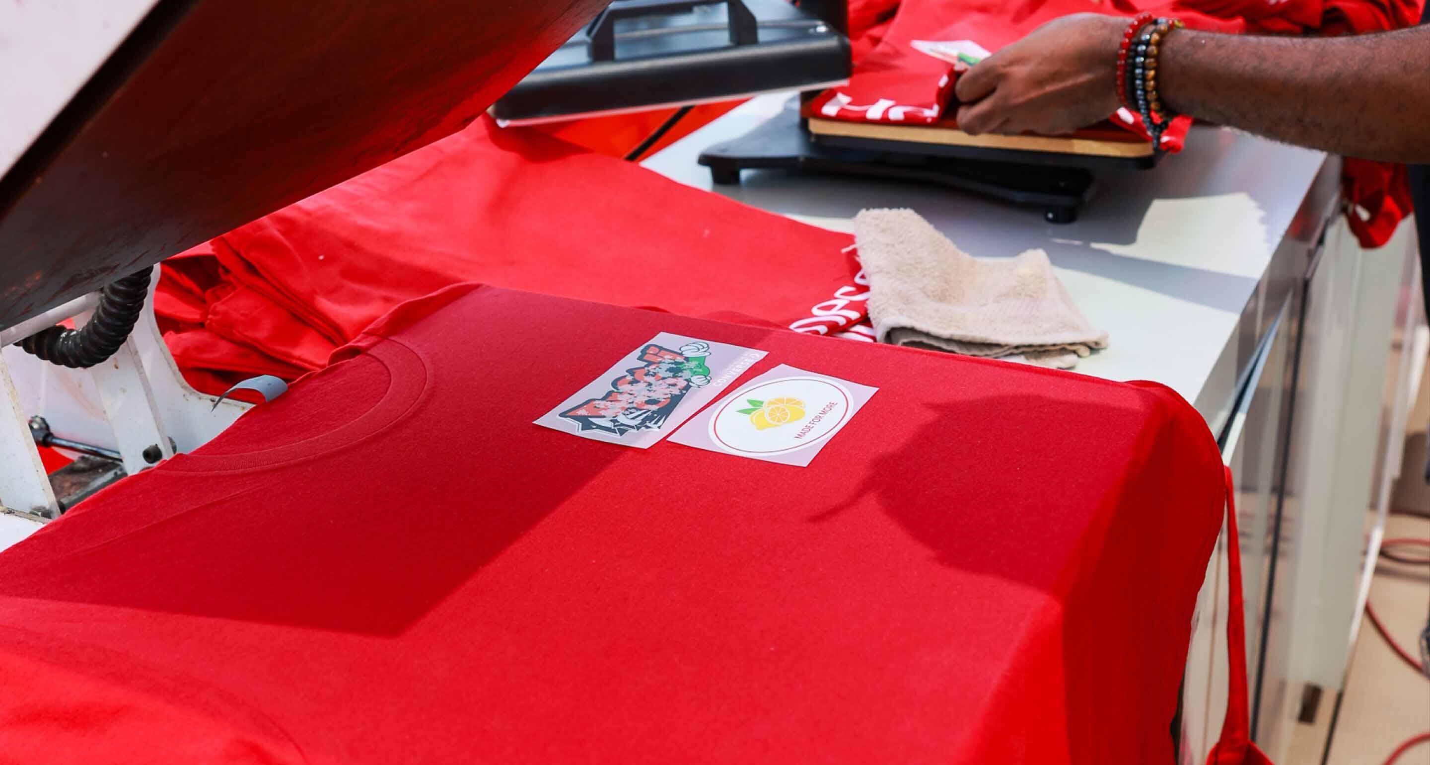 Vibrant Hennessy t-shirts on display, ready for customers to pick up.