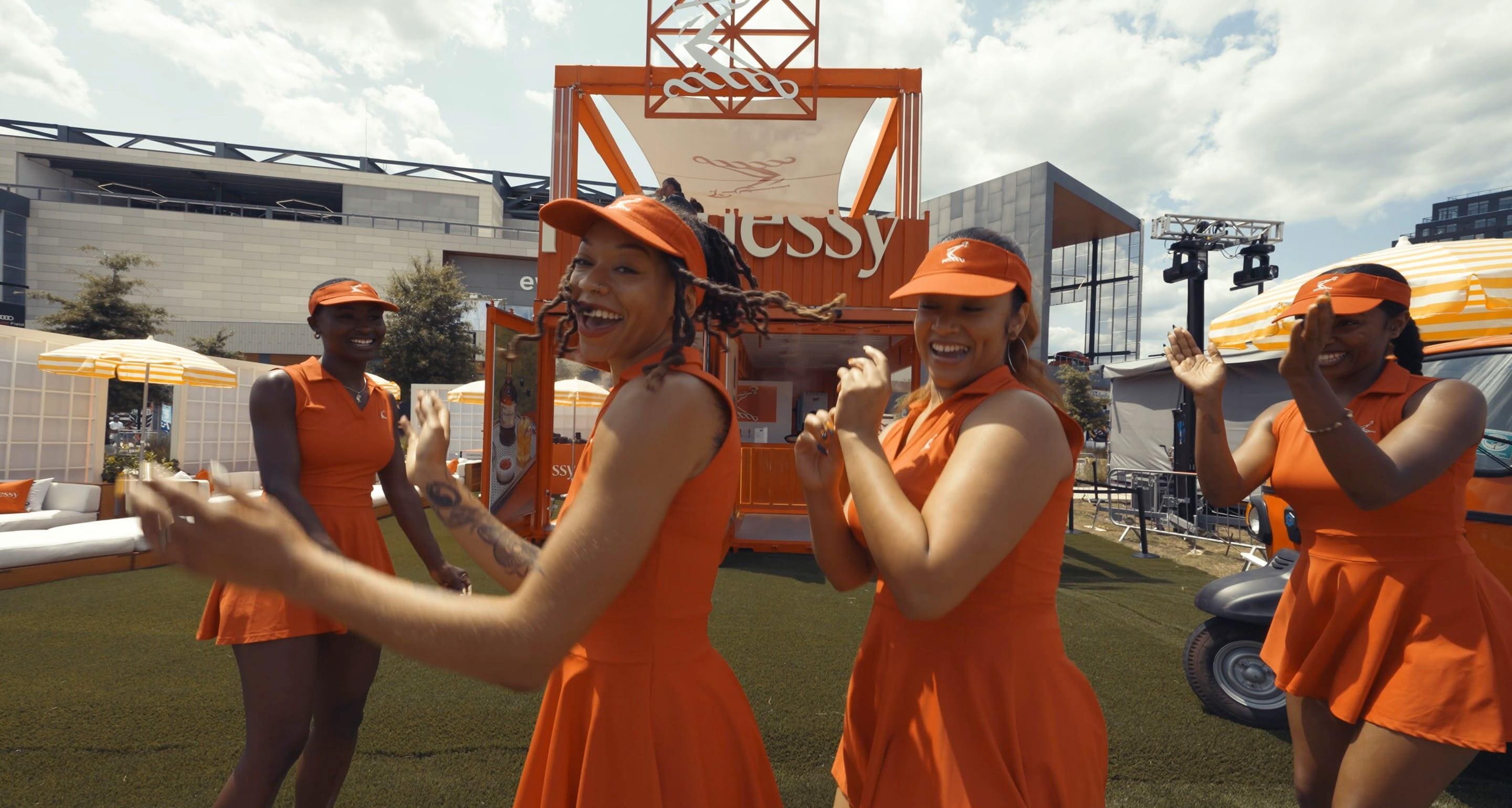 Video of happy festivalgoers dancing, sipping cocktails, and enjoying exclusive brand experiences.