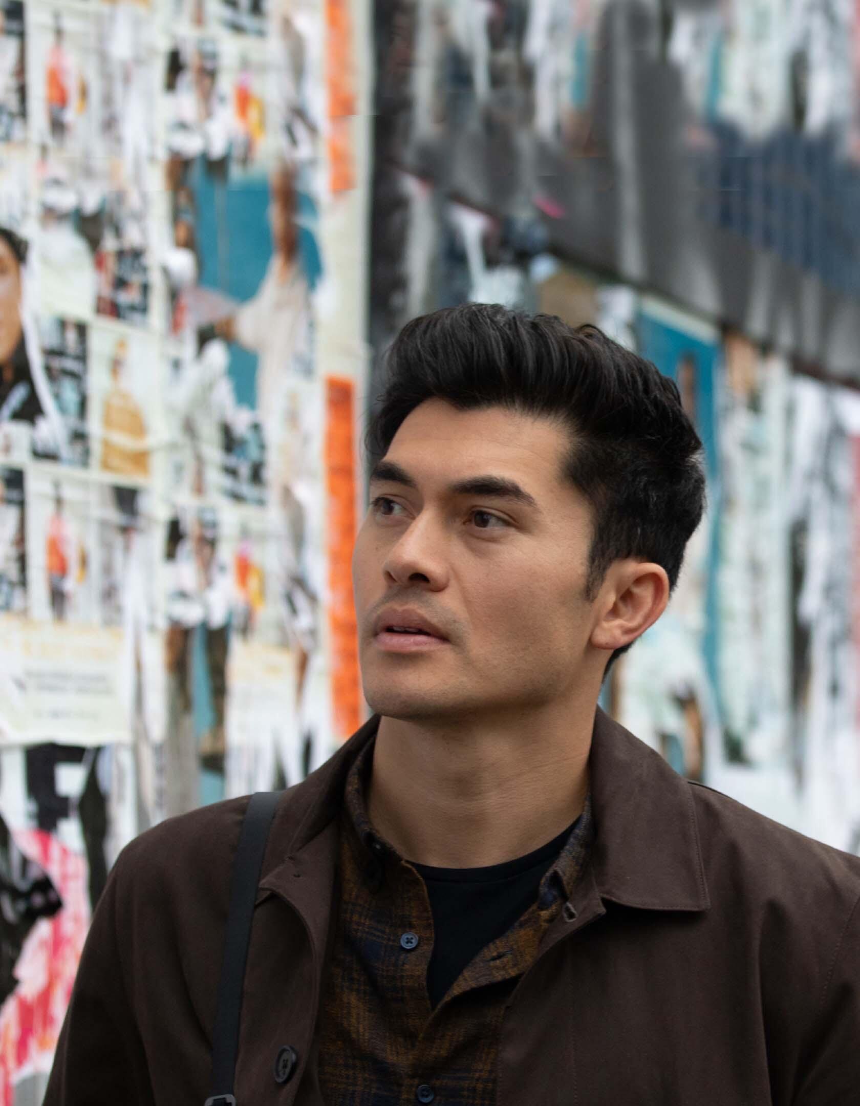 Henry Golding walking through a street in London and reminiscing about growing up there.
