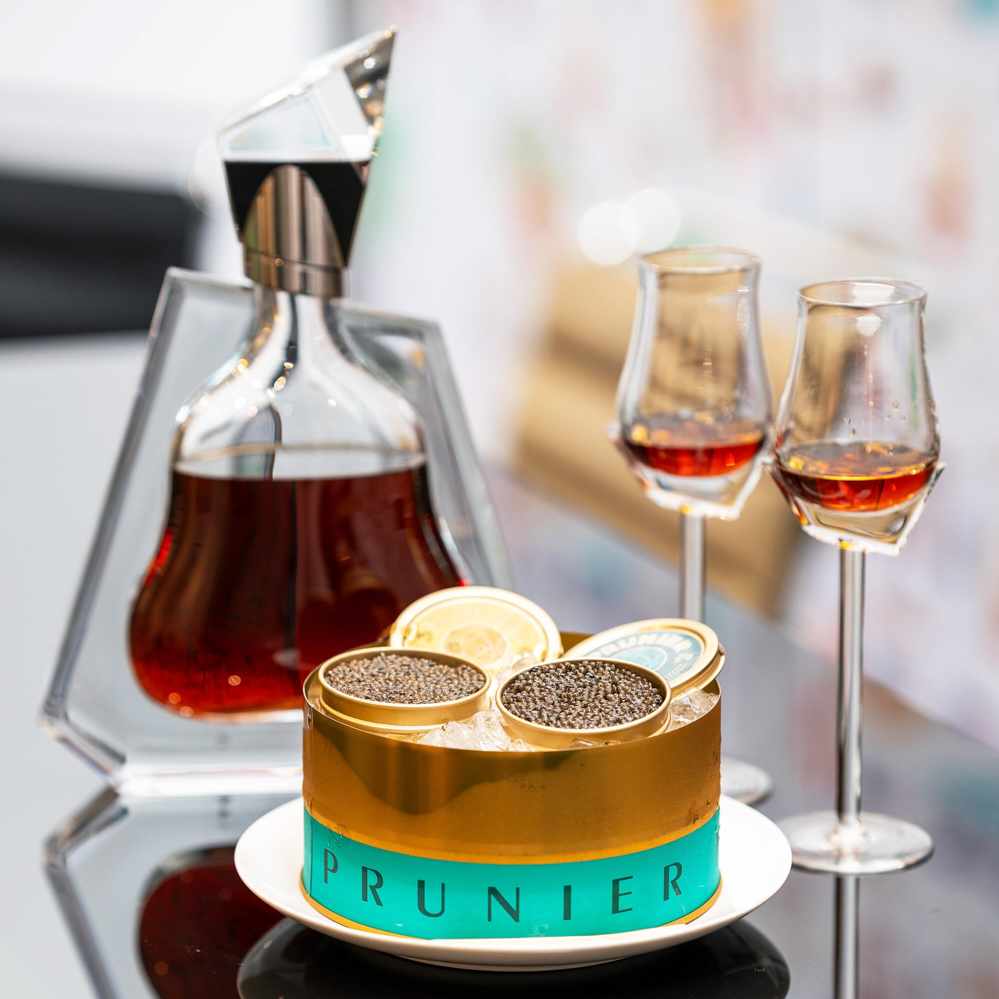 Decanter of Richard Hennessy cognac with 2 glasses and a tin of Prunier Oscietra Caviar